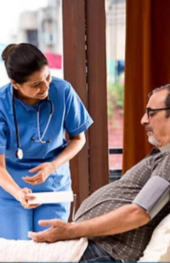 Nurse providing post-operative care to male patient at home